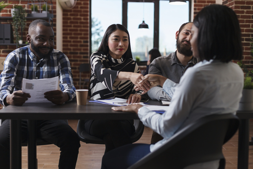 marketing-company-recruiters-sitting-desk-office-while-welcoming-applicant-job-interview-african-american-woman-shaking-recruitment-team-leader-hand-while-making-good-first-impression (1) marketing-company-recruiters-sitting-desk-office-while-welcoming-applicant-job-interview-african-american-woman-shaking-recruitment-team-leader-hand-while-making-good-first-impression (1)